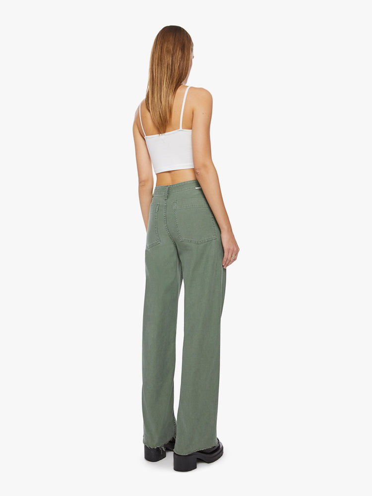 Back view a woman army green super high waisted pants with a loose straight leg, side slit pockets, a long 33.5-inch inseam and a frayed hem.
