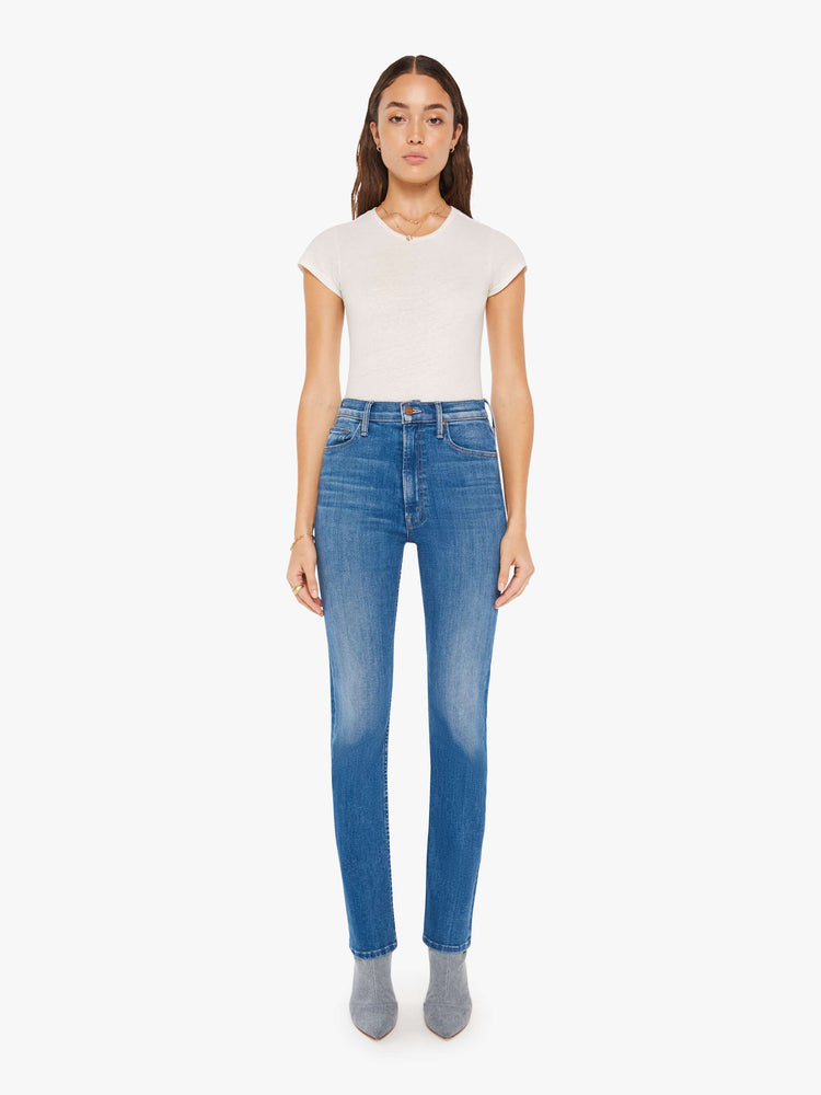 Front view of a woman mid blue high-waisted straight leg has a 31-inch inseam and a clean hem.