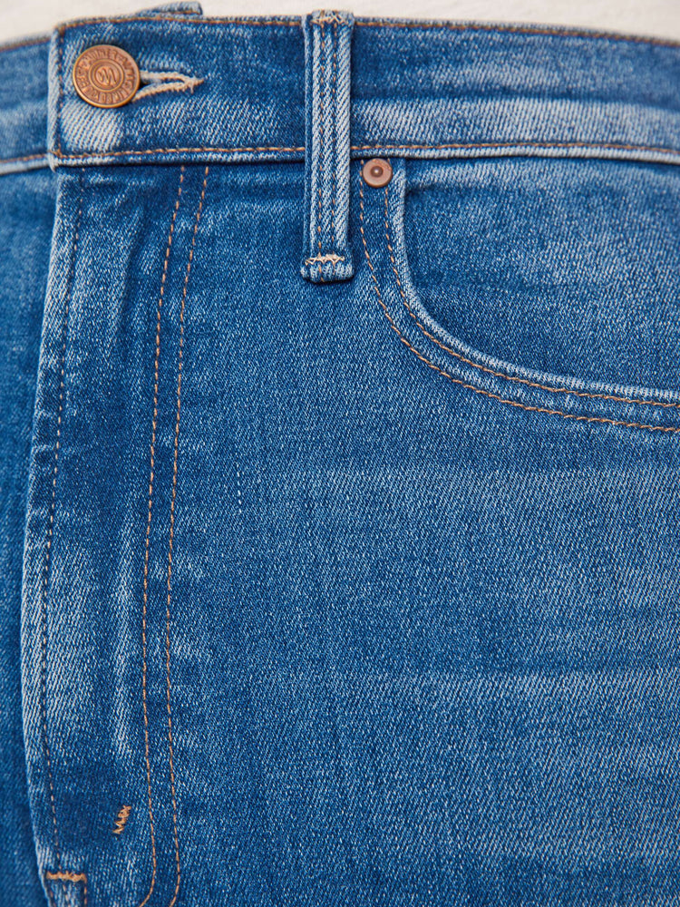 Swatch view of a woman mid blue high-waisted straight leg has a 31-inch inseam and a clean hem.