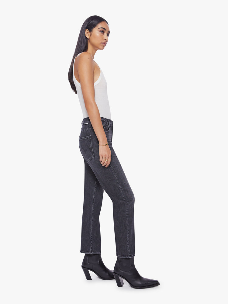 Side view of a woman faded black ankle-length jeans with a zip fly, slouchy straight leg and relaxed fit that's designed to sit on the hips.