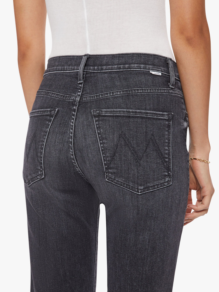 Back waist view of a woman faded black ankle-length jeans with a zip fly, slouchy straight leg and relaxed fit that's designed to sit on the hips.