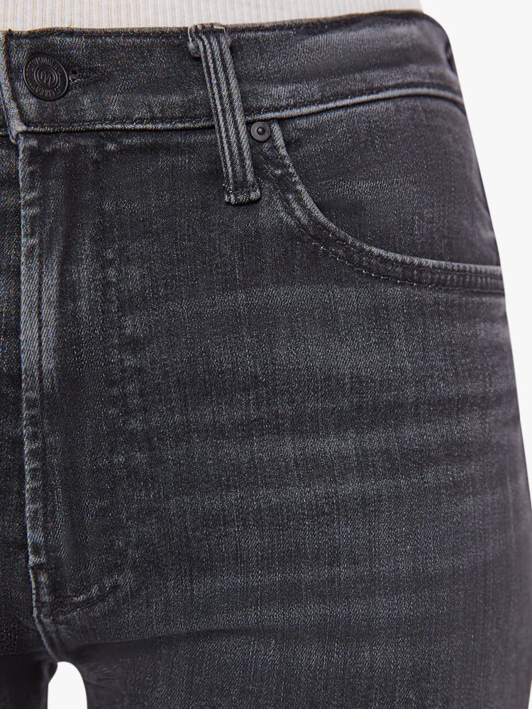 Waist close up view of a woman faded black ankle-length jeans with a zip fly, slouchy straight leg and relaxed fit that's designed to sit on the hips.