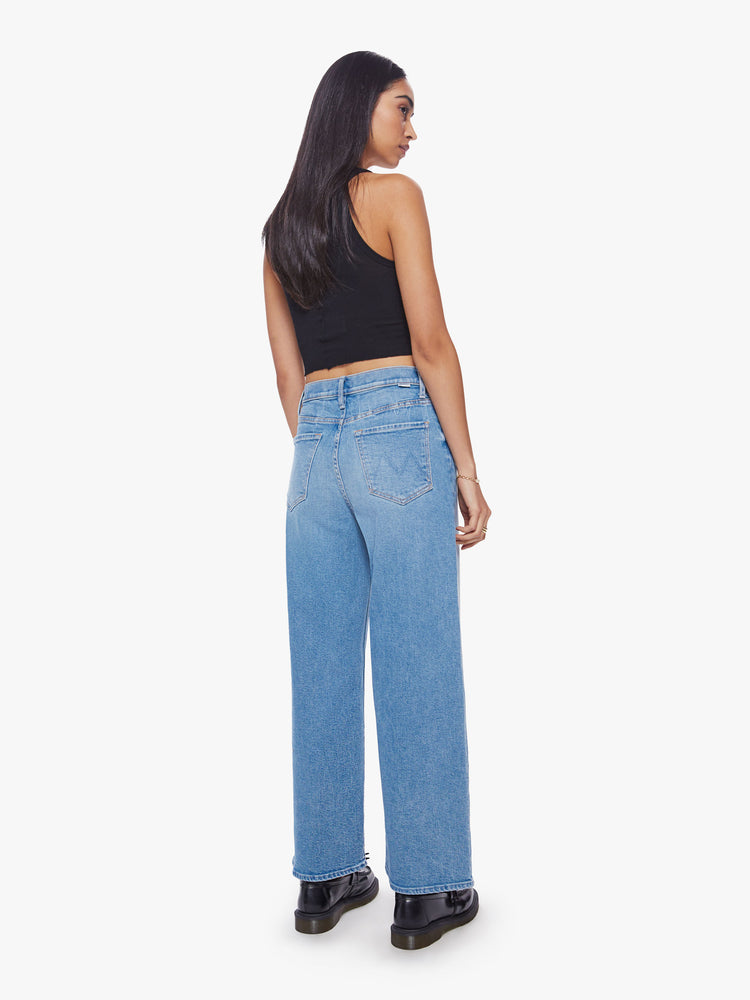 Back view of a super high-rise jeans with a loose wide leg, button fly and a clean hem in a mid-blue wash.