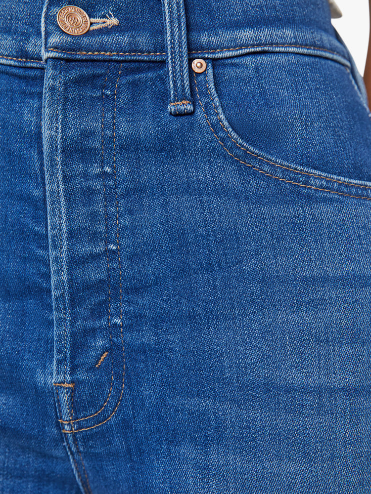 Swatch view of a woman slim straight leg with a button fly, low-set back pockets, high waist and a 29-inch inseam in mid blue wash.