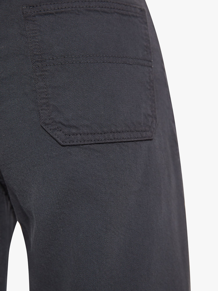 Back pocket close up view of a woman faded black super high-waisted pants with deep, double patch pockets, a wide straight leg and a cropped hem.
