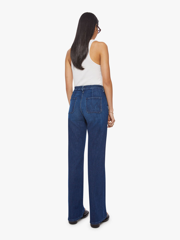 Back view of a women super high-waisted jeans with a loose fit, slit pockets, tied waist and 34-inch inseam with a clean hem.
