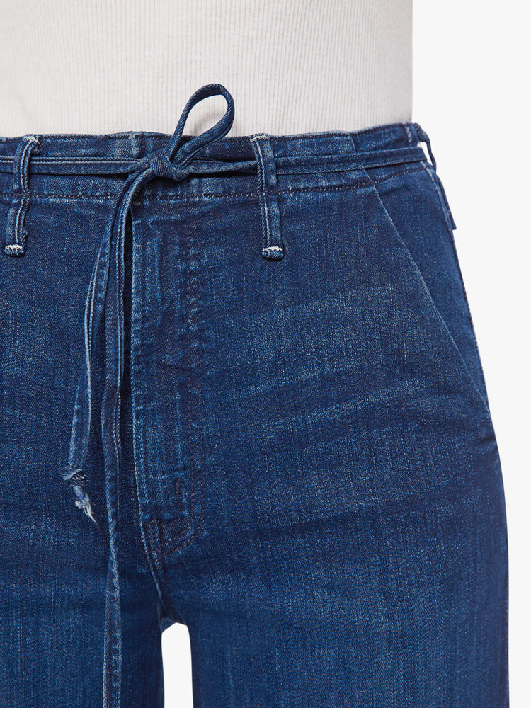 Swatch view of a women super high-waisted jeans with a loose fit, slit pockets, tied waist and 34-inch inseam with a clean hem.