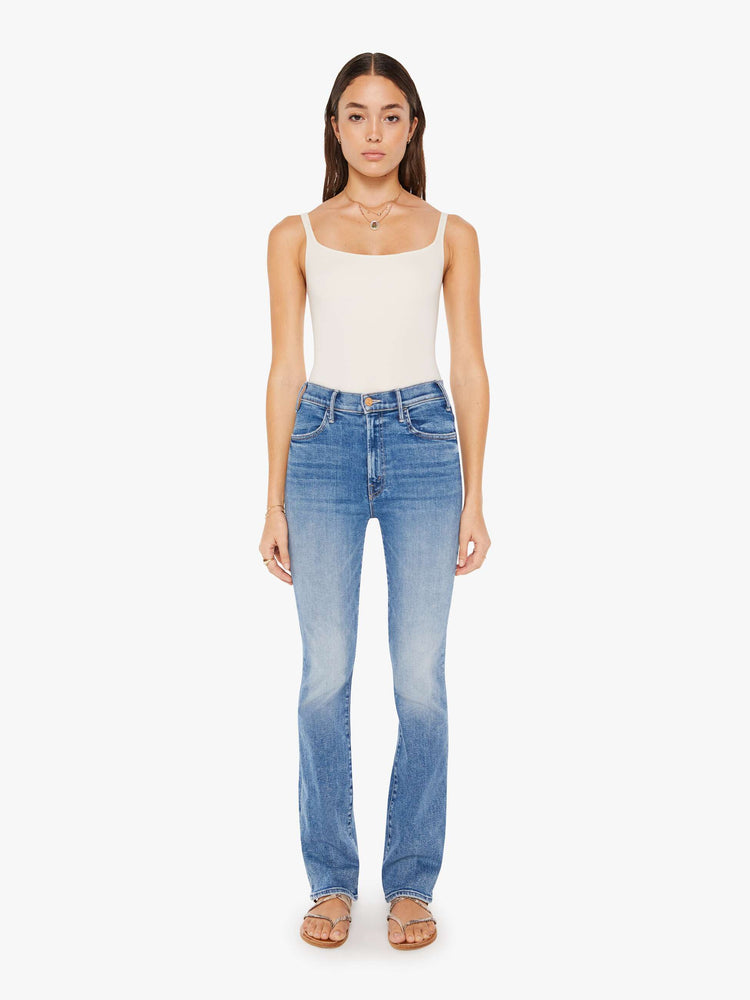 Front view of a womens medium blue wash jean featuring a high rise and a flare leg.