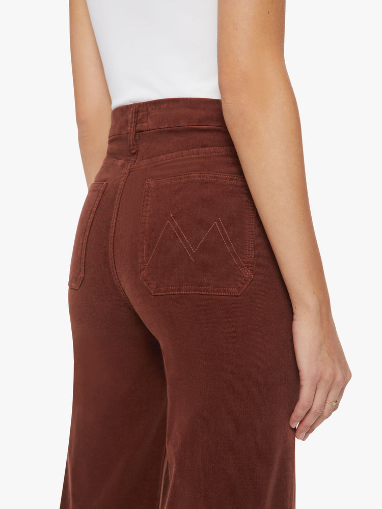 Back close up view of a woman wide-leg pants with a high rise, long inseam, patch pockets and a clean hem in a maroon-brown hue.