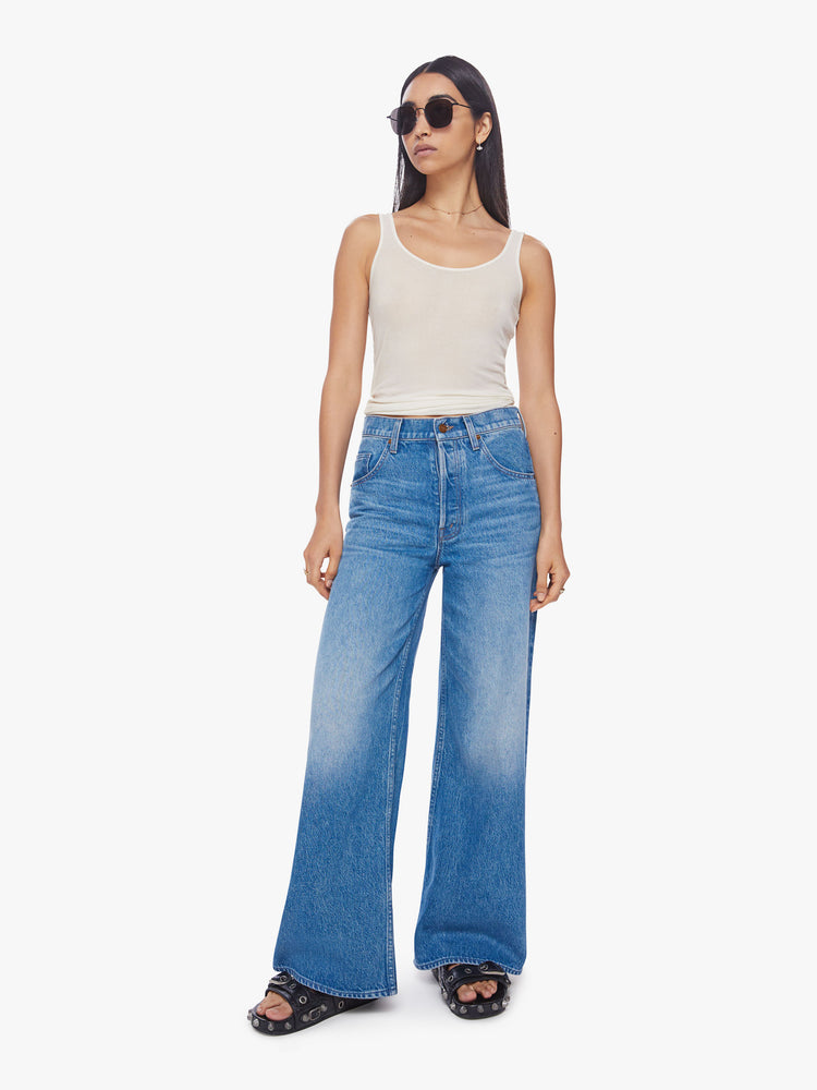 Front view of a woman mid-rise wide leg jean with a button fly, slouchy, loose fit and a 30-inch inseam in a mid-blue wash.