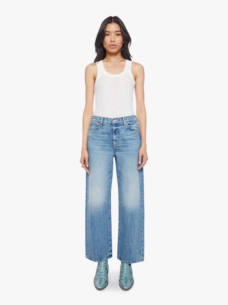 Front view of a woman in jeans designed to sit on the hips with a slouchy fit, a loose straight leg, zip fly and a 28.25-inch inseam with a clean hem.