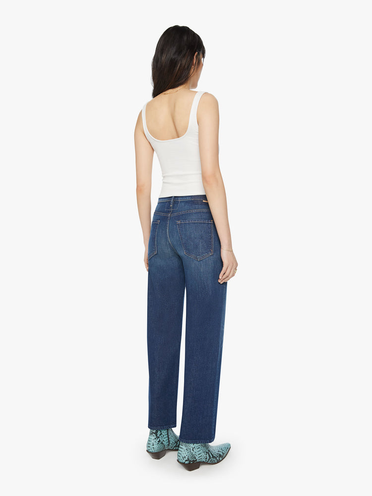 Back view of a woman high-waisted jean with a loose wide leg, 28.25-inch inseam and a clean hem in a dark blue wash.