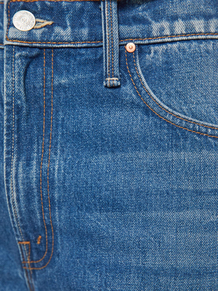 Swatch view of a woman in a med blue jeans designed to sit on the hips with a slouchy fit, a loose straight leg, button fly and a 28.25-inch inseam with a clean hem.