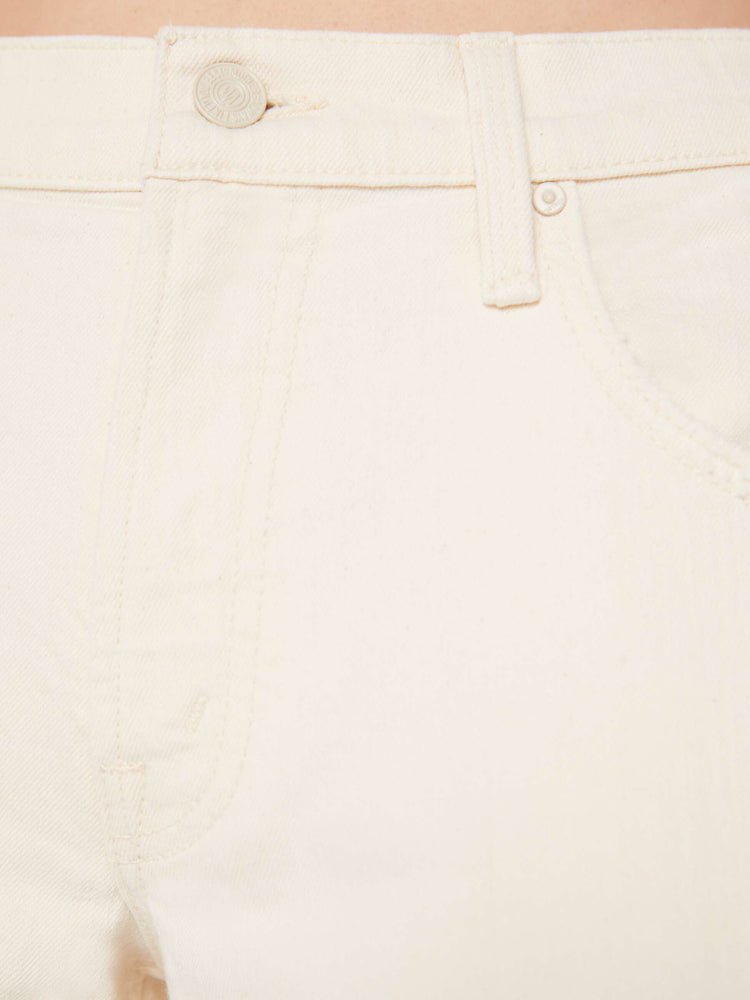 Close up detail swatch view of an off white jean with tonal hardware.