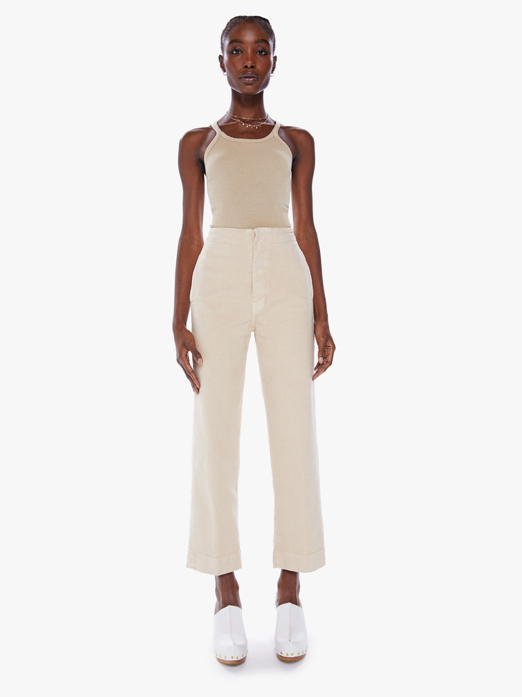Front view of woman wide-leg pants with a high rise, button fly, cinched waist and an ankle-length inseam with a thick hem in a light khaki hue with tonal hardware.