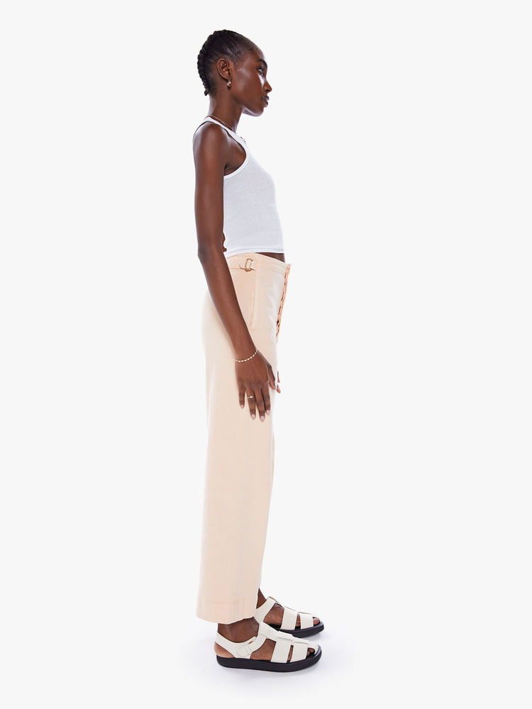 Side ide-leg pants with a high rise, button fly, cinched waist and an ankle-length inseam with a thick hem.