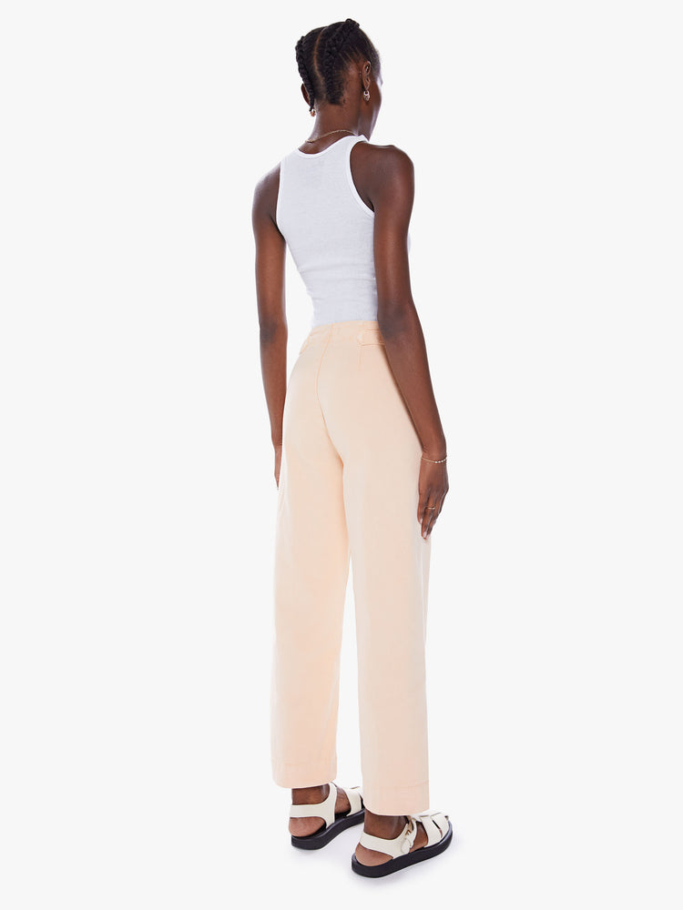 Back ide-leg pants with a high rise, button fly, cinched waist and an ankle-length inseam with a thick hem.