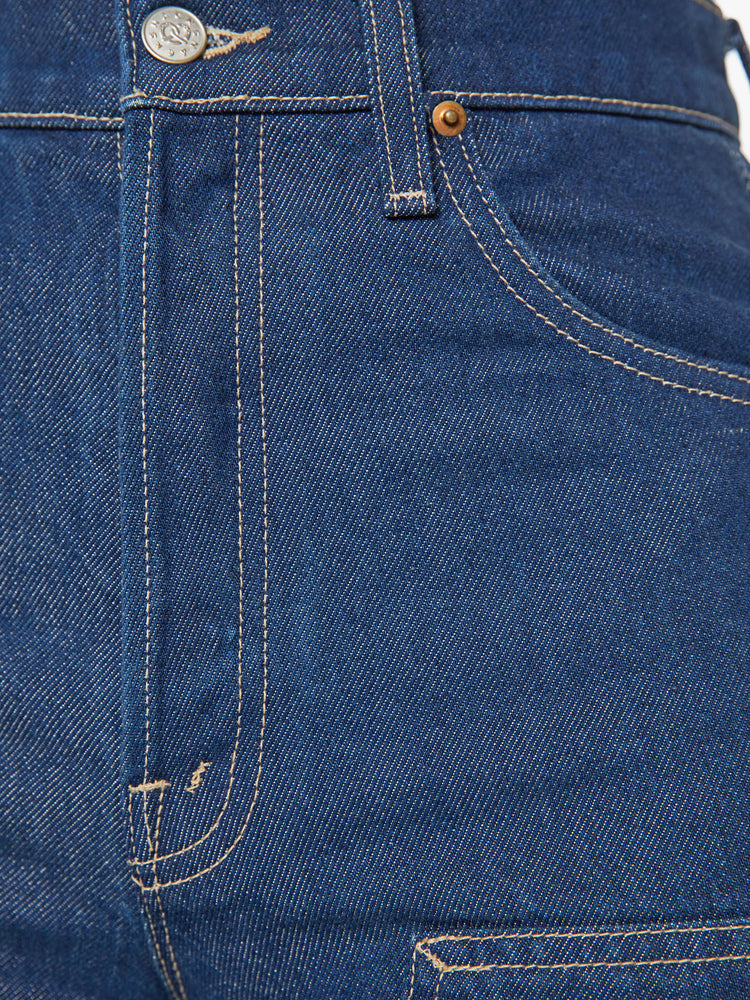 Swatch view of a woman super high-rise jeans are designed with a button fly, slouchy, loose fit, panels at the knee and a 31-inch inseam with a clean hem in a wide leg dark blue wash.