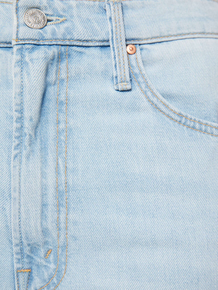 Swatch view of a woman in a light blue jeans designed to sit on the hips with a zip fly, slouchy fit, loose straight leg and a 32-inch inseam with a clean hem.