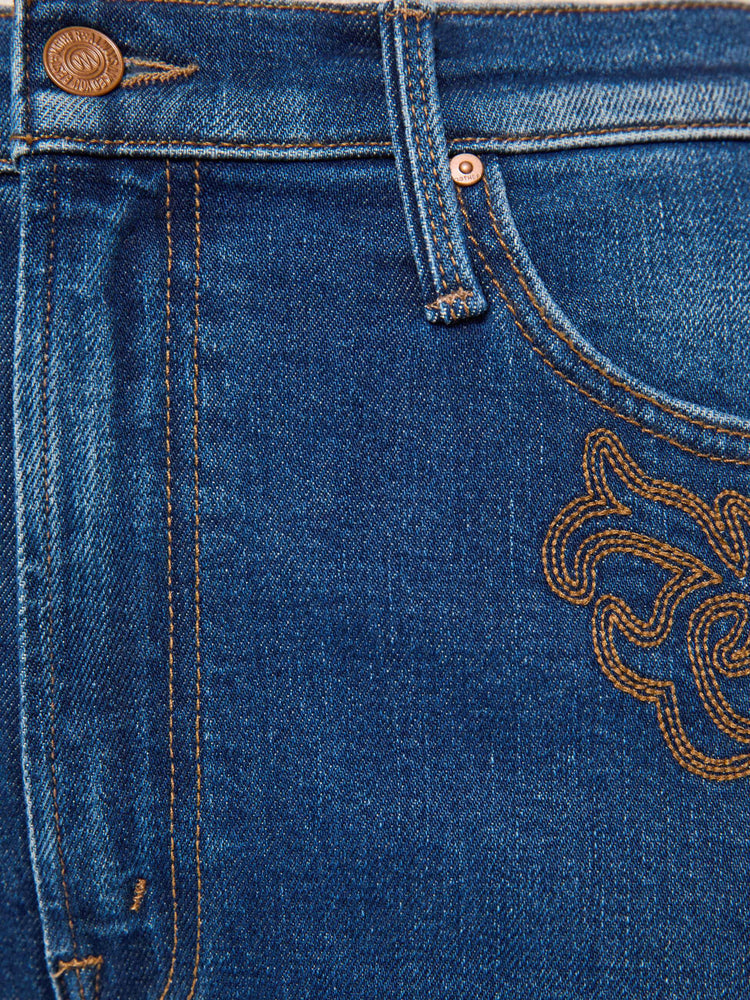 Swatch view of a woman in a med blue jeans designed to sit on the hips with a zip fly, slouchy fit, loose straight leg and a 32-inch inseam with a clean hem.