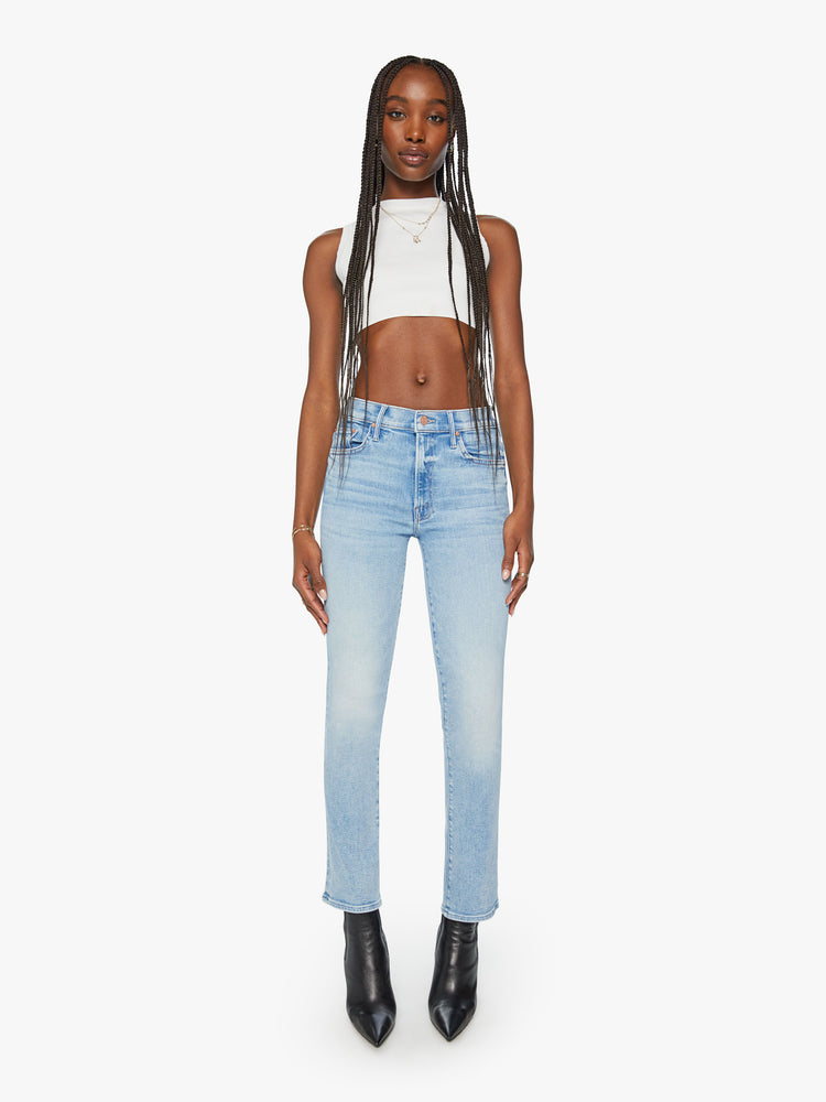 Front view of a woman light blue mid-rise bootcut has a 29.25-inch inseam and a clean hem.