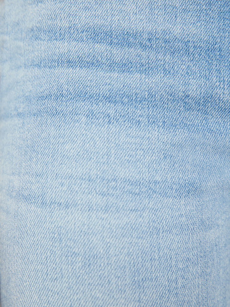Swatch view of a woman light blue mid-rise bootcut has a 29.25-inch inseam and a clean hem.