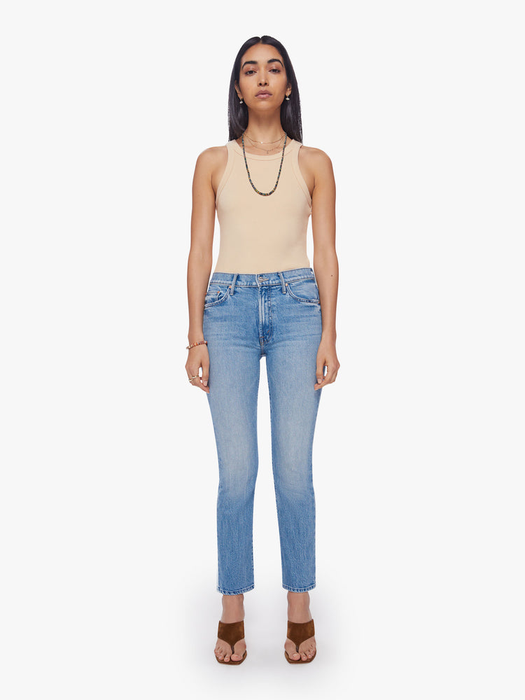 Front view of a woman  mid-rise bootcut has a 28.25-inch inseam and a clean hem in a vintage blue wash.
