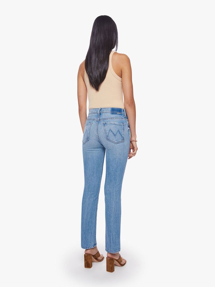 Back view of a woman mid-rise bootcut has a 28.25-inch inseam and a clean hem in a vintage blue wash.