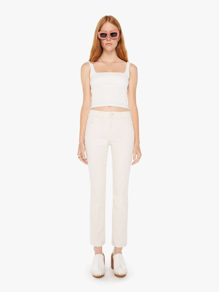 Front view of a woman light khaki cream colored  high-rise bootcut has a 28.25-inch inseam and a clean hem pant.