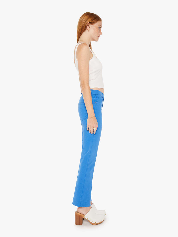 Side view of a woman high-rise bootcut has a 28.25-inch inseam and a clean hem in a bright blue.
