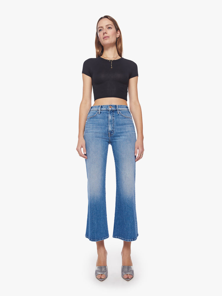 Front view of a woman wide-leg jeans with a high rise, ankle-length inseam and a clean hem in a light blue wash.