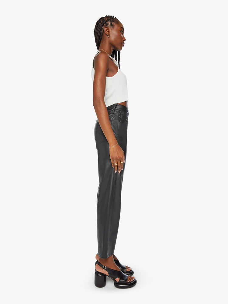 Side view of a high-waisted pants with a wide straight leg, zip fly and clean ankle-length inseam in a black faux leather.