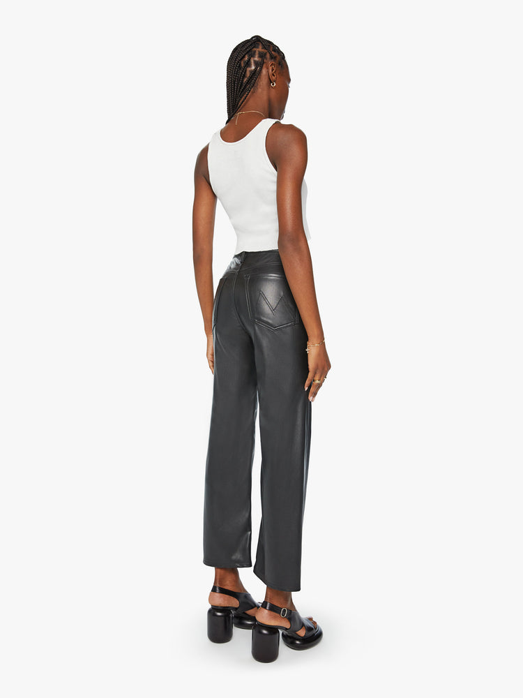 Back view of a high-waisted pants with a wide straight leg, zip fly and clean ankle-length inseam in a black faux leather.