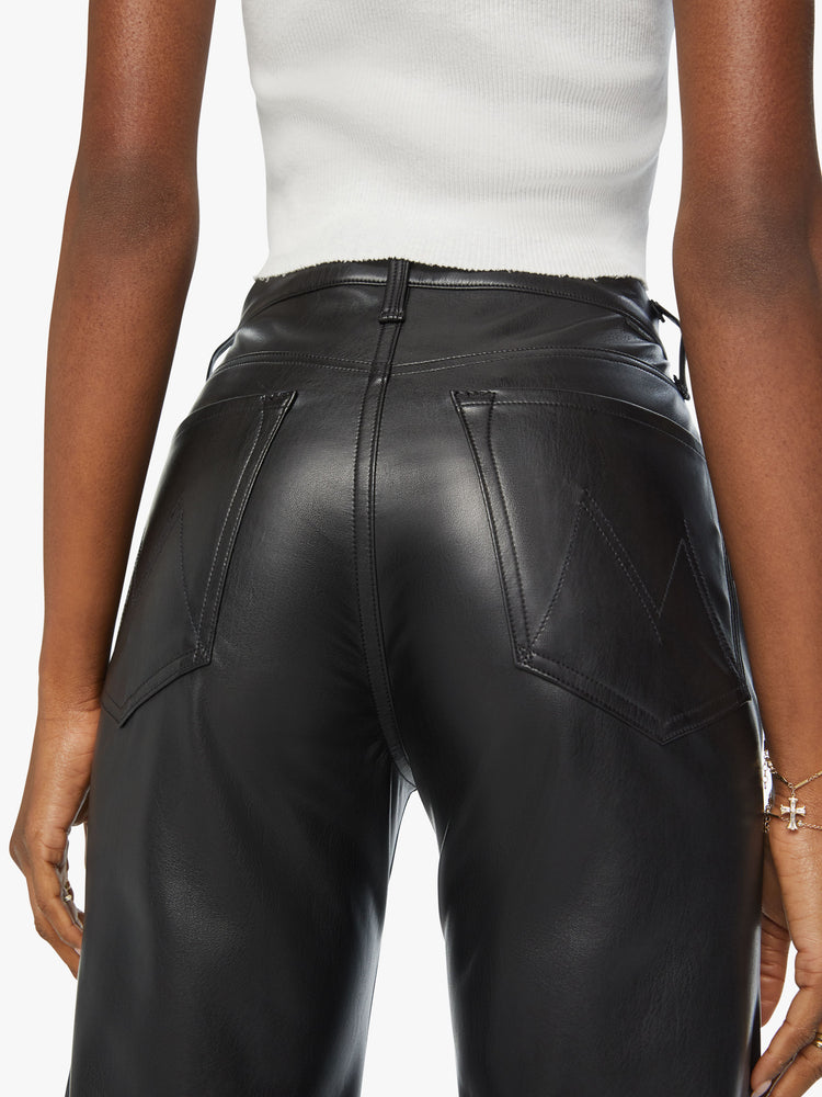 Back waist view of a high-waisted pants with a wide straight leg, zip fly and clean ankle-length inseam in a black faux leather.