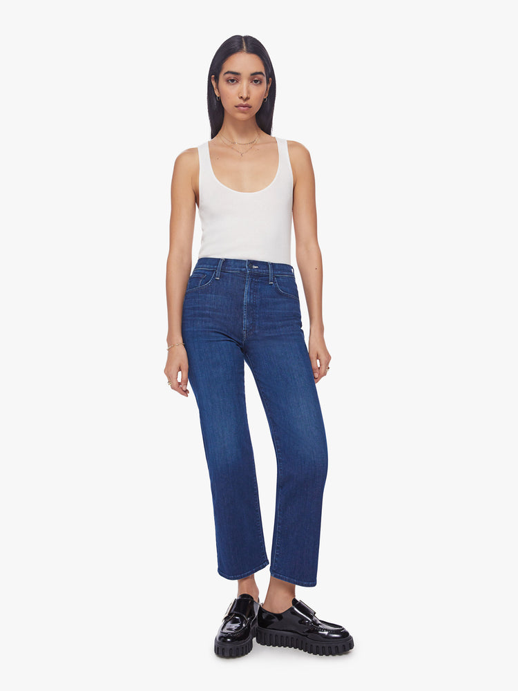 Front view of a woman high-waisted jeans with a wide straight leg, zip fly and clean ankle-length inseam in dark blue wash.