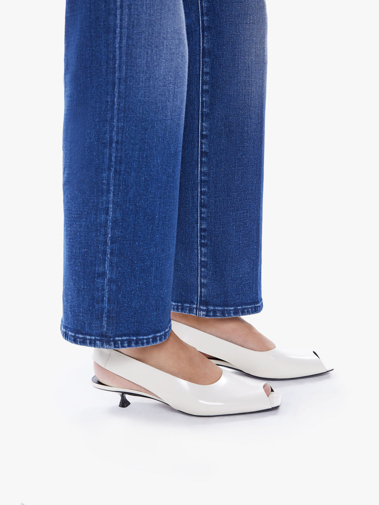 Hem view of a woman high-waisted jean with a wide straight leg, zip fly and clean ankle-length inseam in an ocean-blue hue.