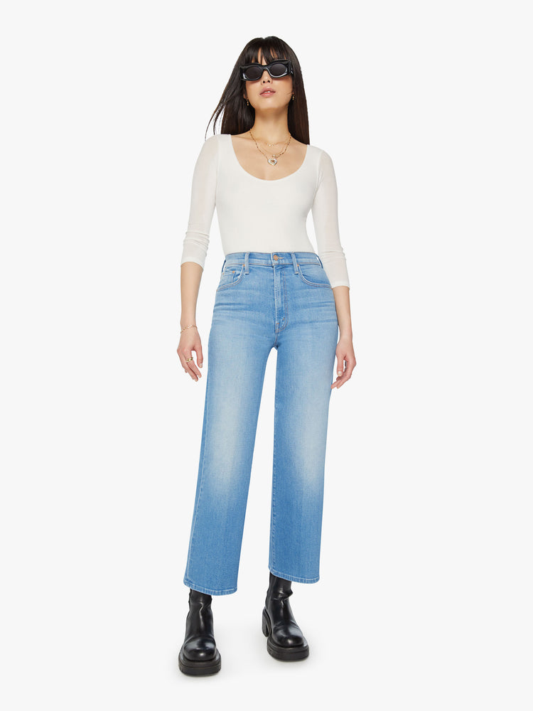 Front view of a woman high waisted jeans with a wide straight leg, zip fly and clean ankle-length inseam in a light blue wash.
