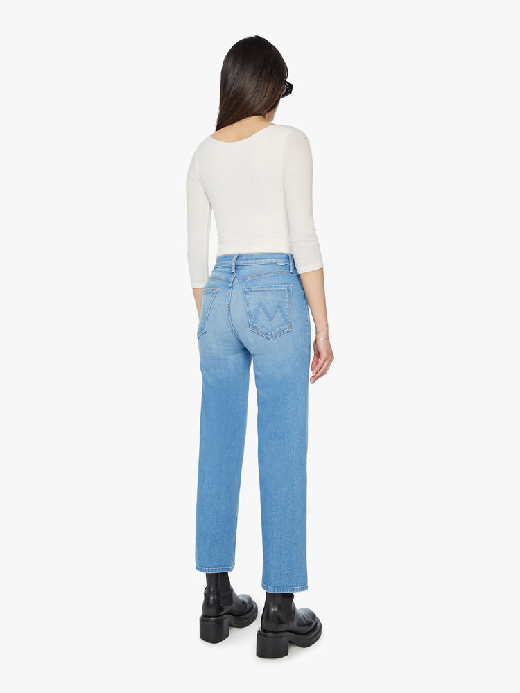 Back view of a woman high waisted jeans with a wide straight leg, zip fly and clean ankle-length inseam in a light blue wash.