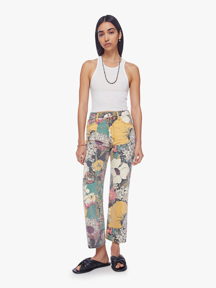 Front view of a woman high-waisted jeans with a wide straight leg, zip fly and clean ankle-length inseam in an oversized floral print. 
