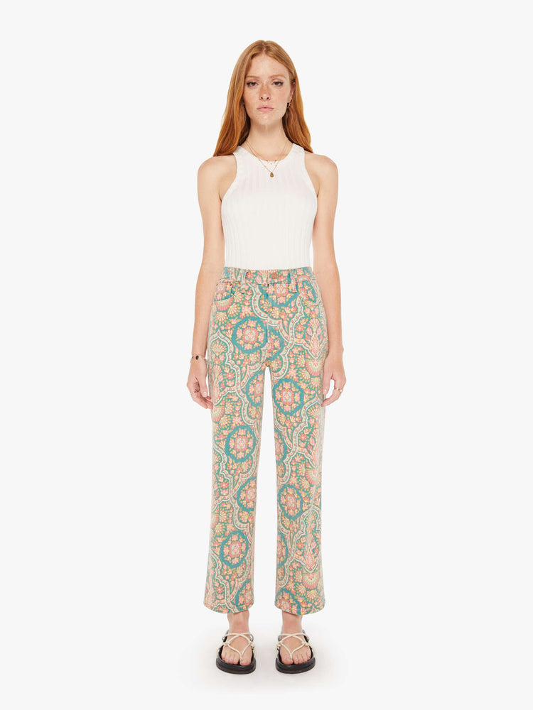 Front view of a womens high rise pant in a mult color rug inspired print.