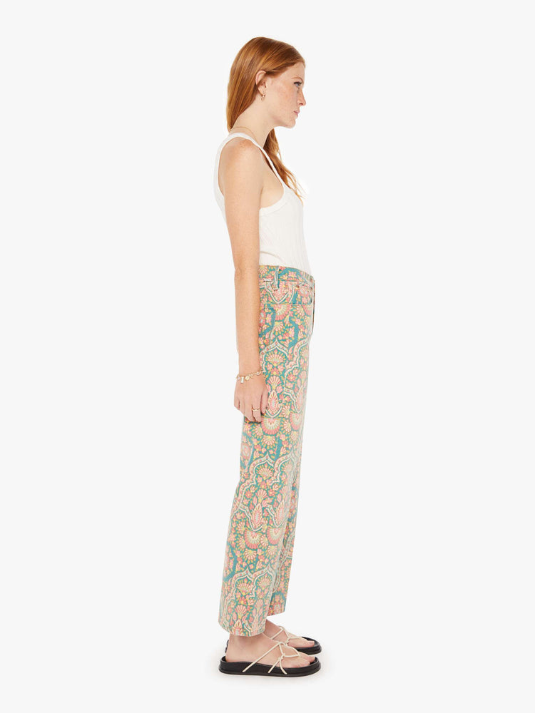 Side view of a womens high rise pant in a mult color rug inspired print.