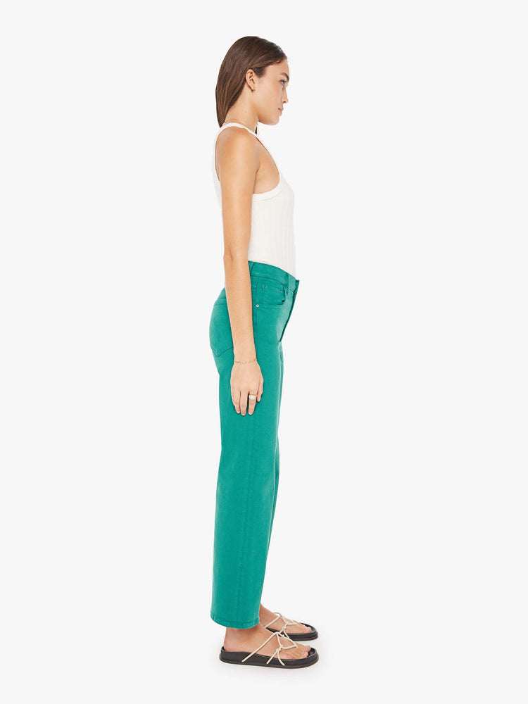Side view of a womens green pant featuring a high rise, a wide straight leg, and an ankle length clean hem.