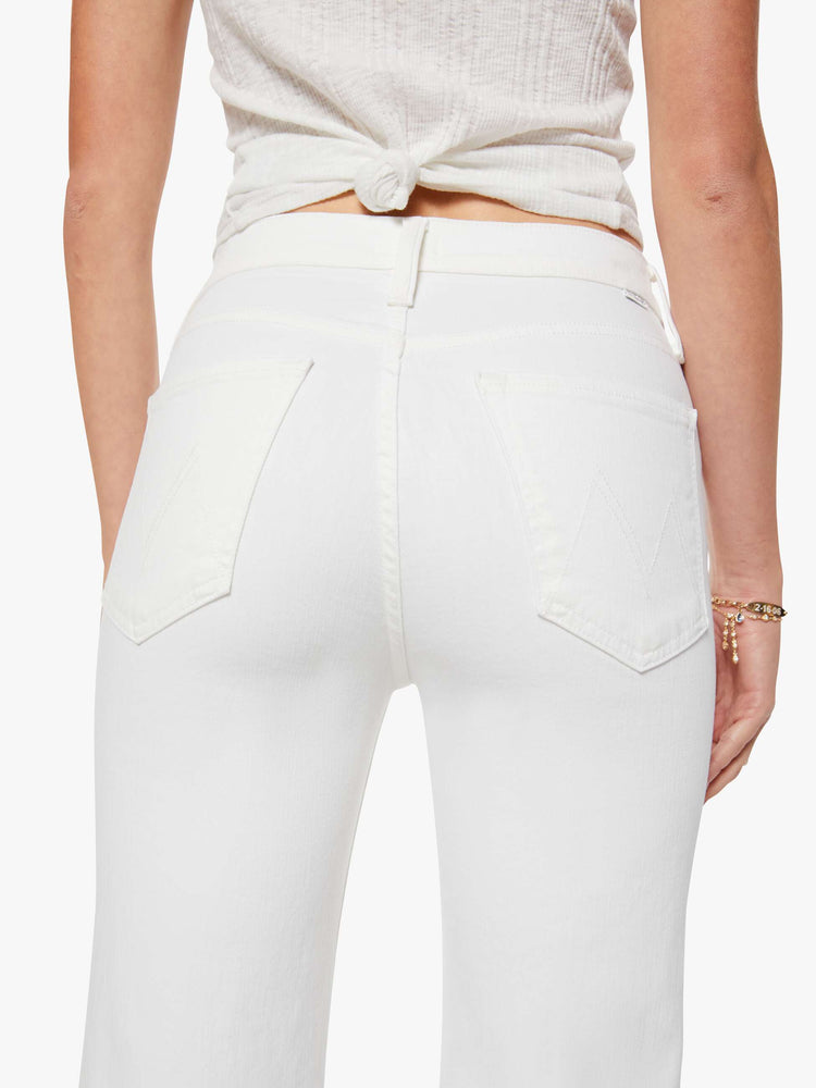 Back close up view of a womens white high waisted wide straight leg jean with an ankle length inseam and zip fly.