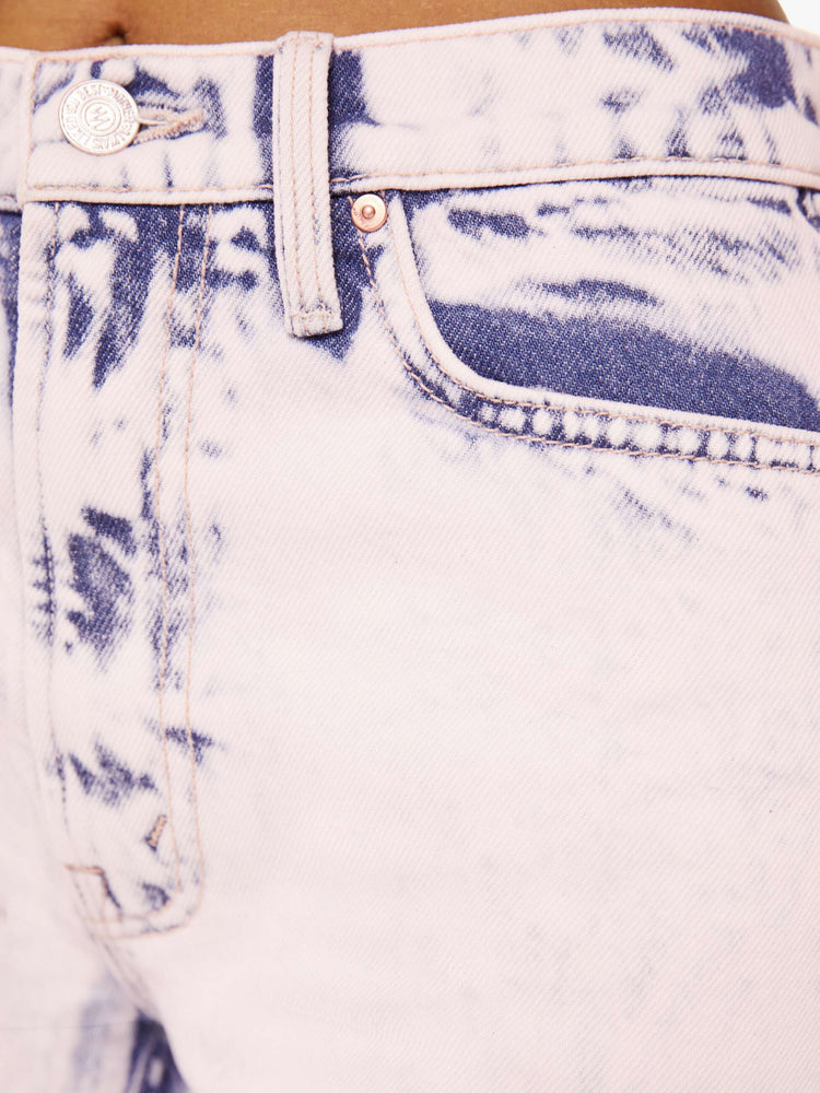 swatch view of jeans that are acid-washed and overdyed in a soft light pink with darker spots throughout.