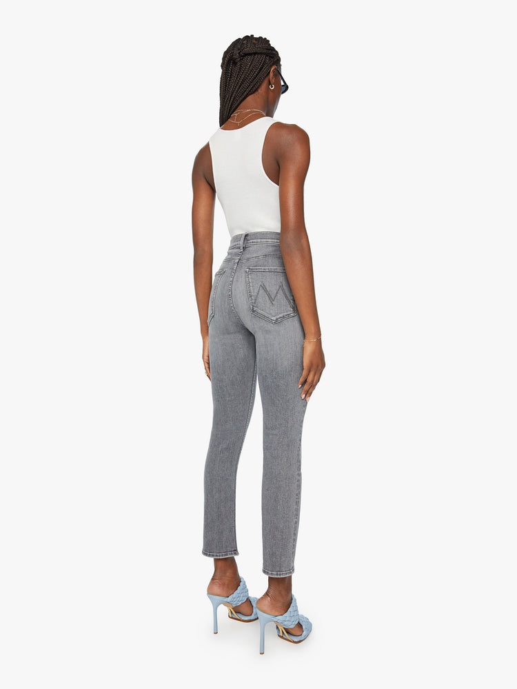 Back view of a woman high-waisted straight leg with an ankle-length inseam and a clean hem in a faded grey wash.