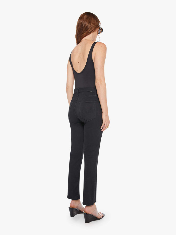 Back view of a woman in a black high-waisted straight leg with an ankle-length inseam and a clean hem.