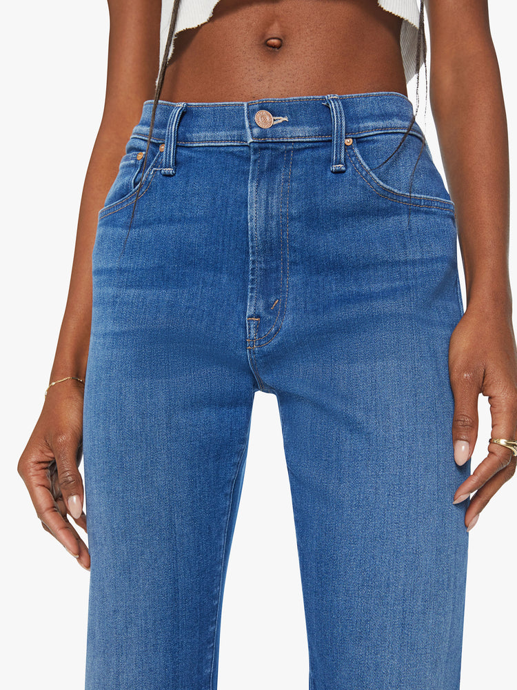 Waist view of a woman mid rise straight-leg jeans with a zip fly, 31-inch inseam and relaxed fit in a mid blue wash.
