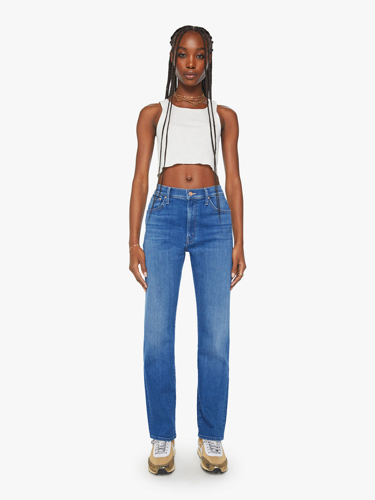 Front view of a woman mid rise straight-leg jeans with a zip fly, 31-inch inseam and relaxed fit in a mid blue wash.