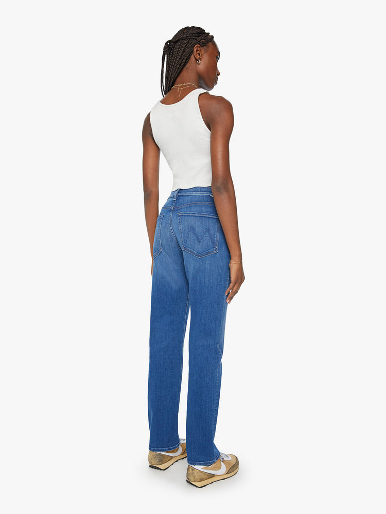 Back view of a woman mid rise straight-leg jeans with a zip fly, 31-inch inseam and relaxed fit in a mid blue wash.