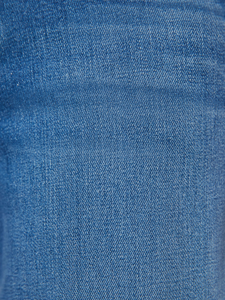 Swatch view of a woman mid-blue wash super high-rise straight-leg jean with a zip fly, wide leg, side slit pockets with braided details and a clean 31-inch inseam.